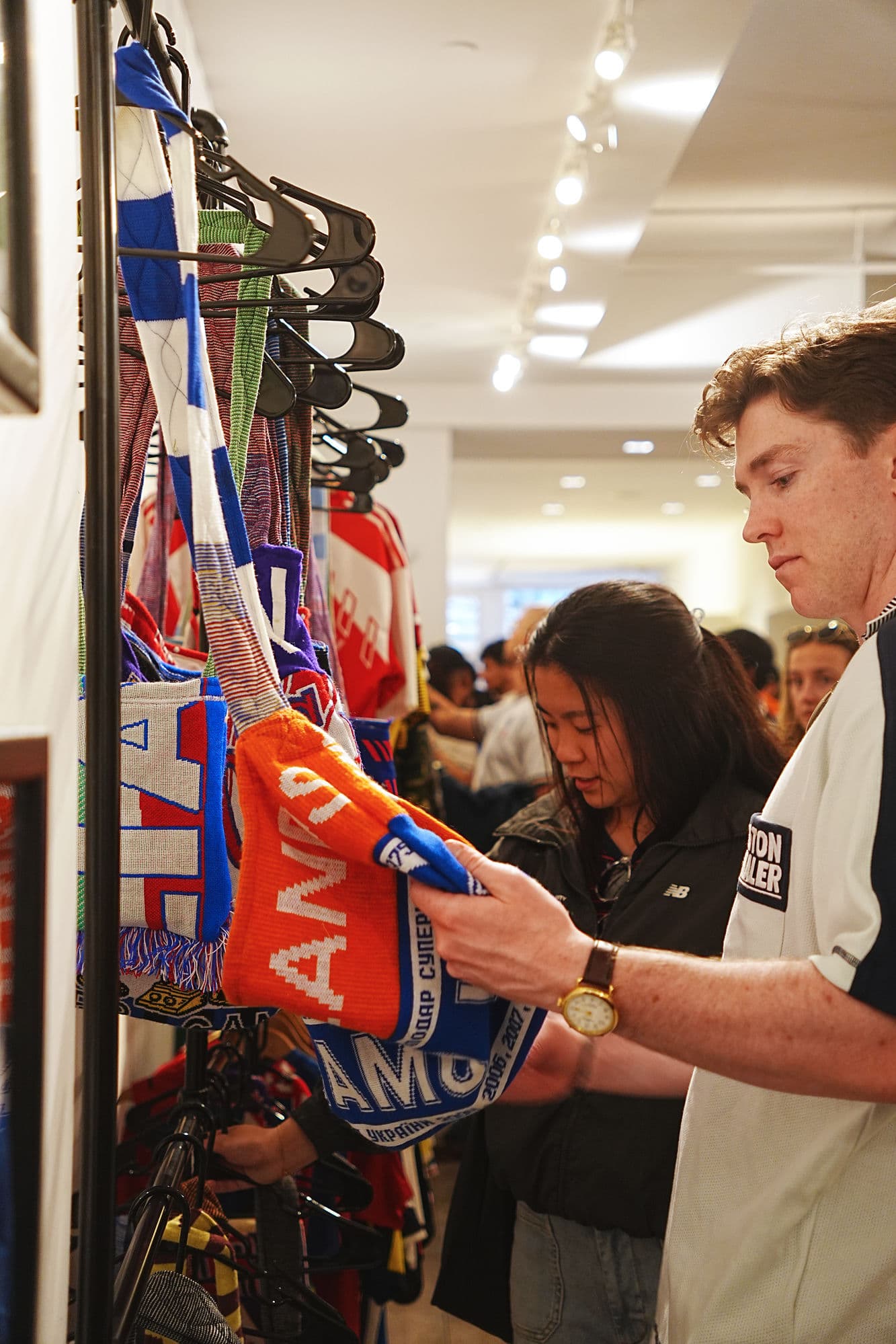 Customers browsing Extra Time bags at a pop-up event