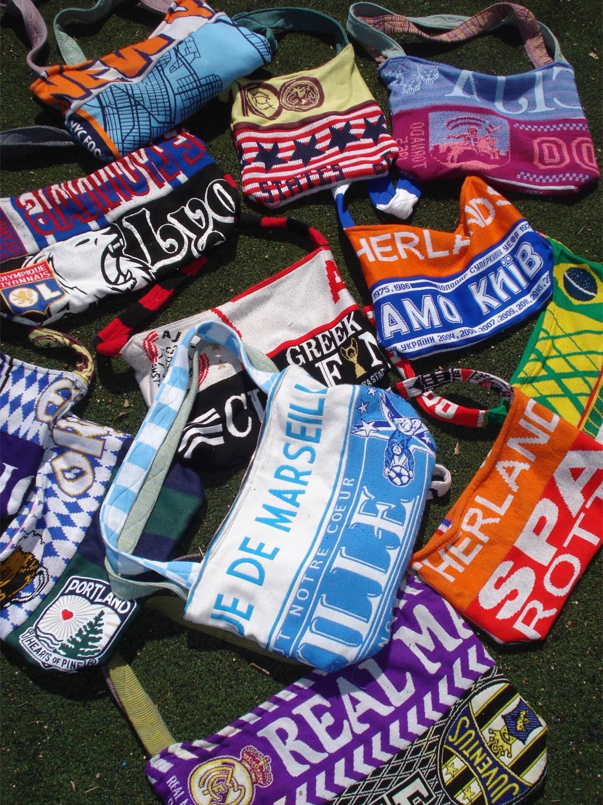 A pile of one-of-a-kind bags made from football scarves from clubs around the world